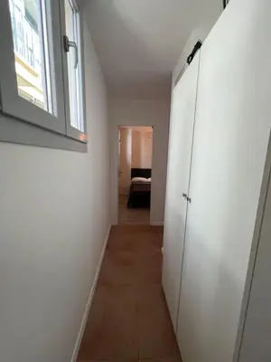 a hallway with a white door and a window at La cour du centre Nice Verde in Nice