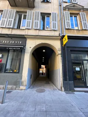 a tunnel leading into a building with a street at La cour du centre Nice Verde in Nice