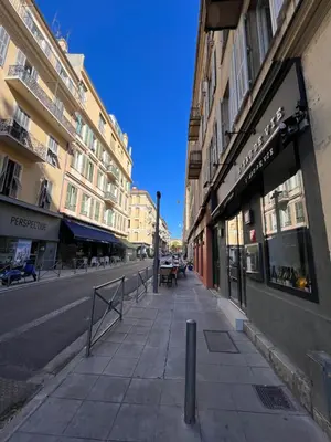 a city street with buildings and a sidewalk at La cour du centre Nice Verde in Nice