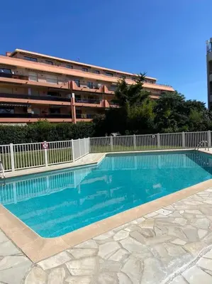 a large swimming pool in front of a building at Pretty Studio Swimming pool and Sea in Cagnes-sur-Mer