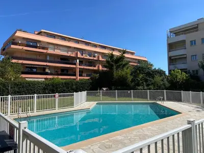 a swimming pool in front of a apartment building at Pretty Studio Swimming pool and Sea in Cagnes-sur-Mer