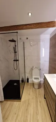 a bathroom with a toilet and a glass wall at Vieux Nice a 2min de la mer in Nice