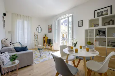 a living room with a couch and a table and chairs at Maison Bianchi - Lamartine in Nice