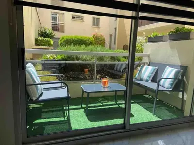a patio with a table and chairs on a balcony at Superbe appartement carré Delfino Port de Nice in Nice