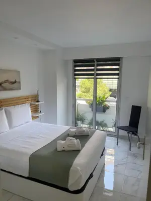 a bedroom with a bed and a chair and a window at Superbe appartement carré Delfino Port de Nice in Nice