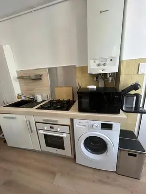 a kitchen with a stove and a washing machine at Nice - Appartement T3 rénové de 50 M2 classé 2 étoiles in Nice