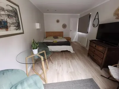 a living room with a bed and a glass table at Villa Soleil Levant in Nice